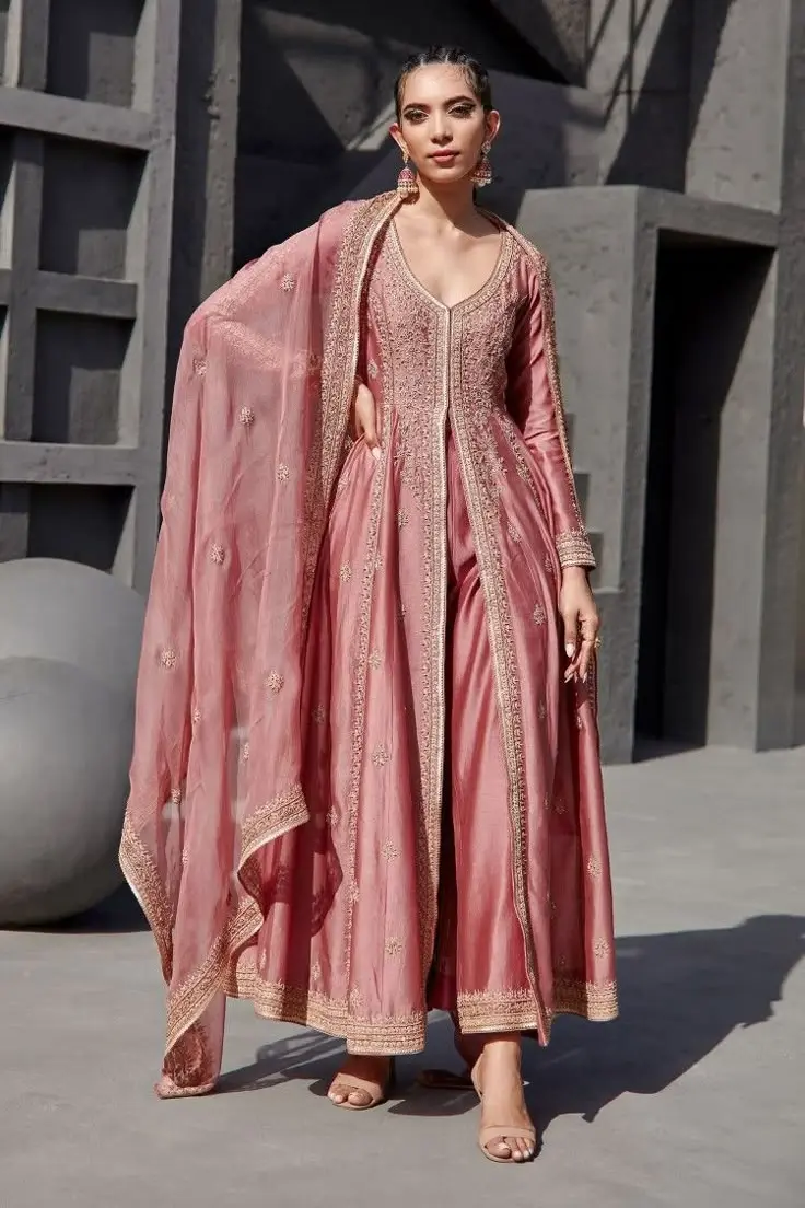  Pink anarkali suit featuring intricate gold embroidery, showcasing a blend of traditional and elegant design elements party wear dresses for women in kerala