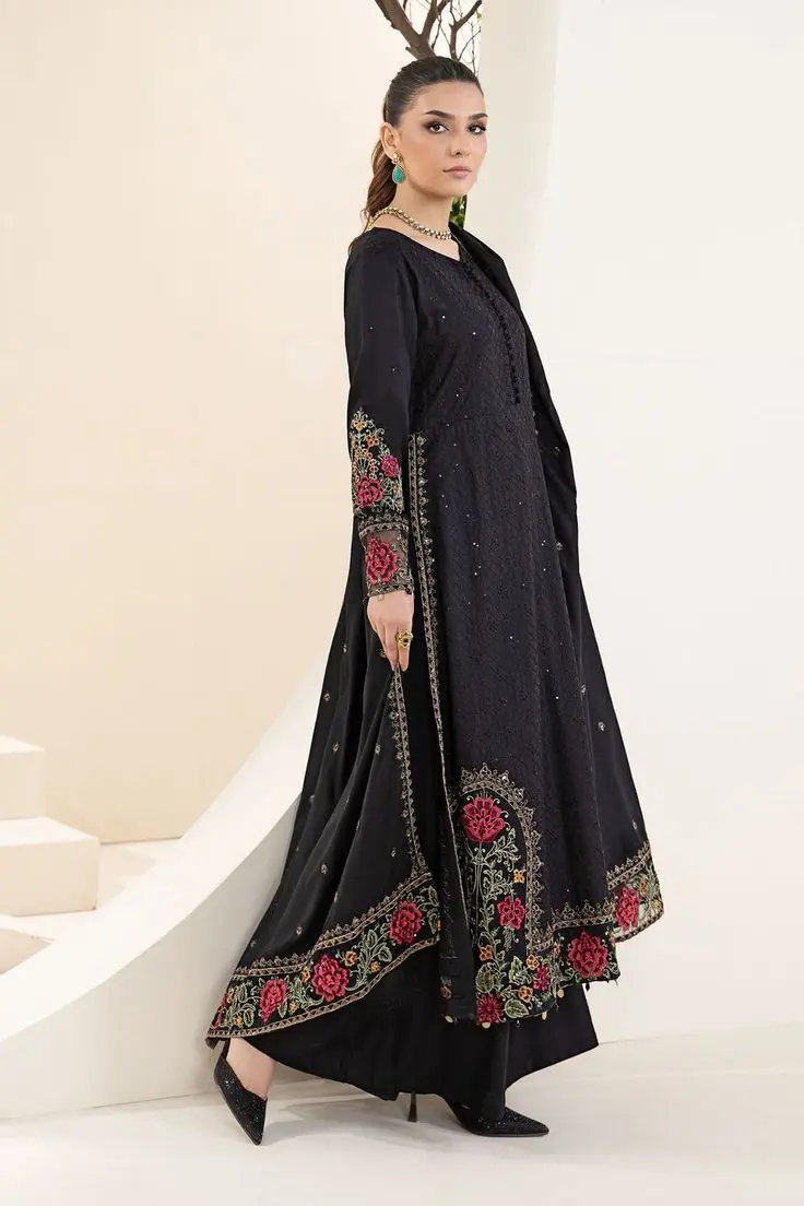black Anarkali suit with intricate red floral embroidery along the sleeves and hem, paired with matching trousers and a dupatta."black Anarkali suit with intricate red floral embroidery along the sleeves and hem, paired with matching trousers and a dupatta."