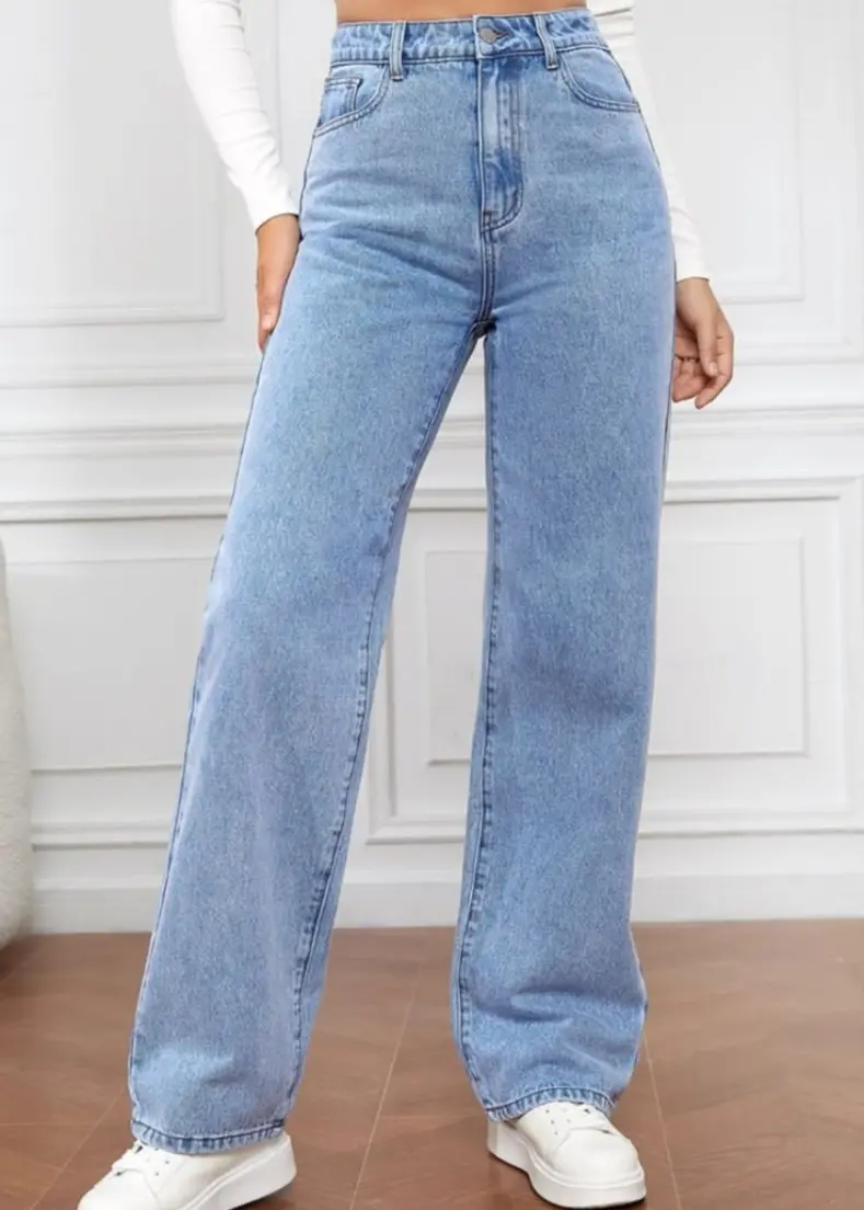 wearing high-rise jeans, standing confidently with her hands on her hips. pants for women in kerala