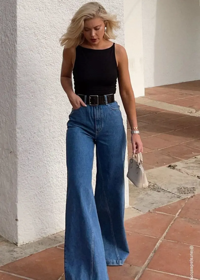 denim pants raflo clothing wide-leg jeans stands confidently, showcasing a casual yet stylish outfit. Pants for women in kerala
