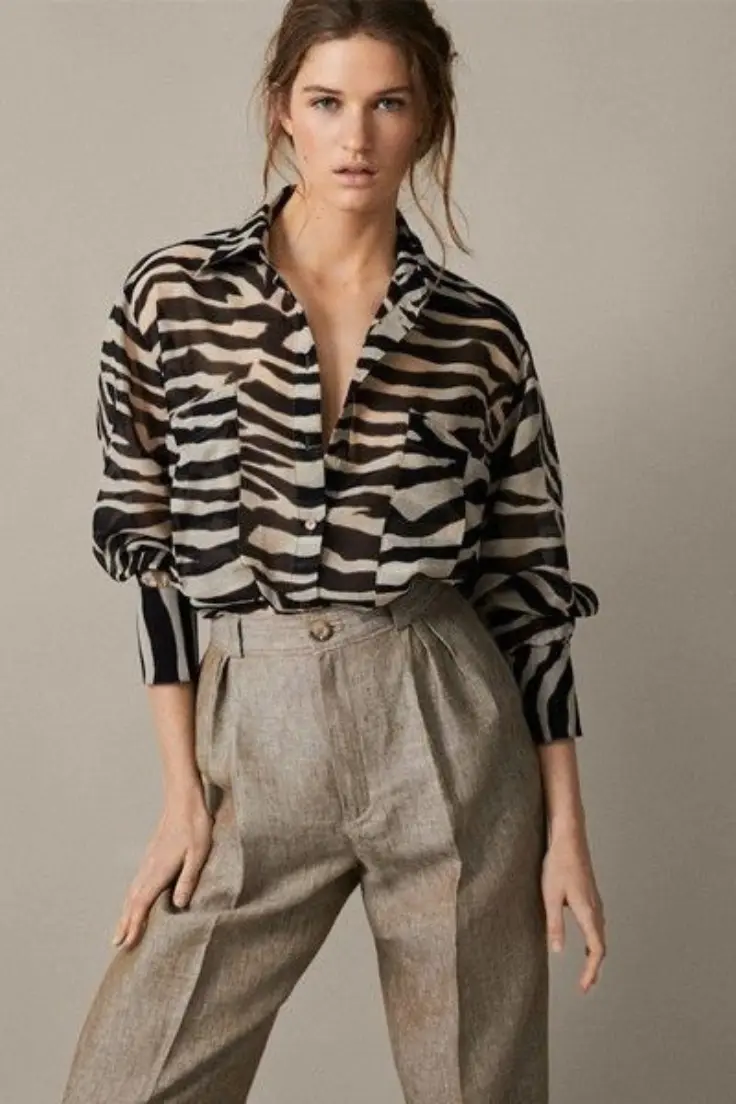  A model showcases a stylish zebra print shirt paired with matching pants, highlighting a bold fashion statement western dress for women in kerala